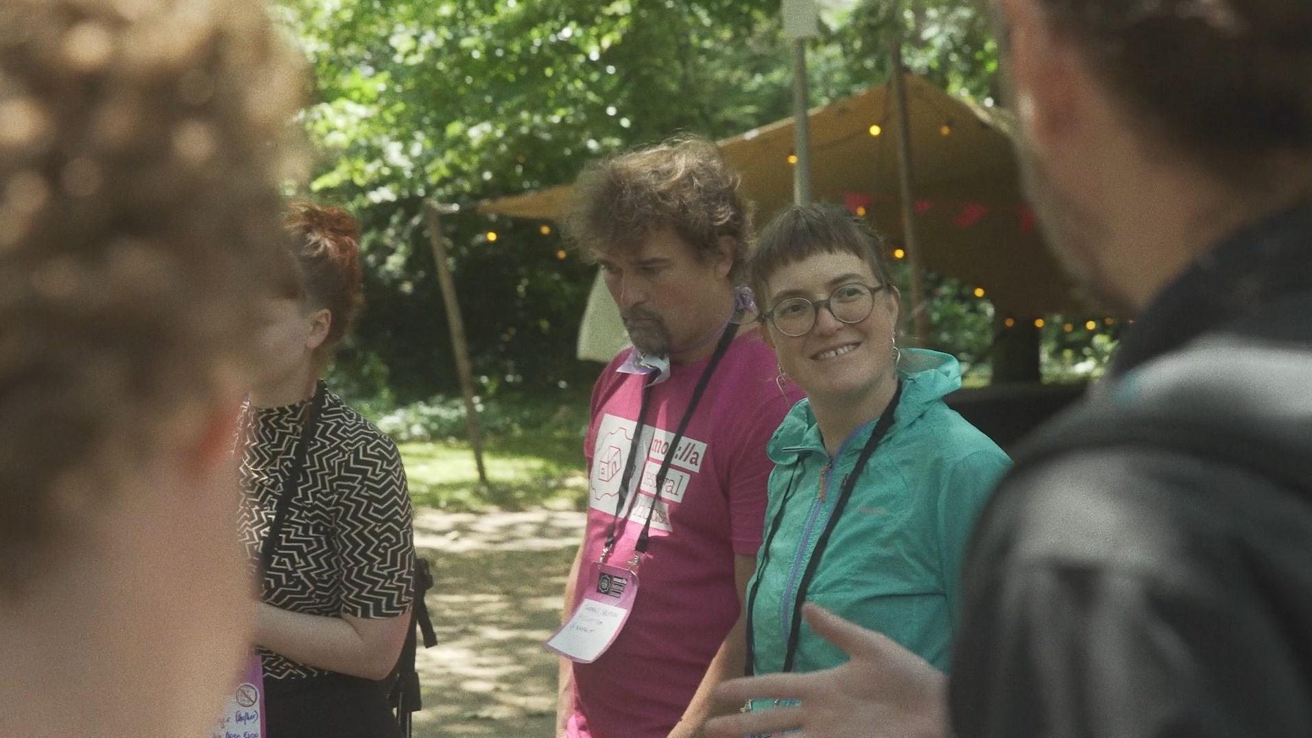 Group of people looking at each other and smiling in conversation